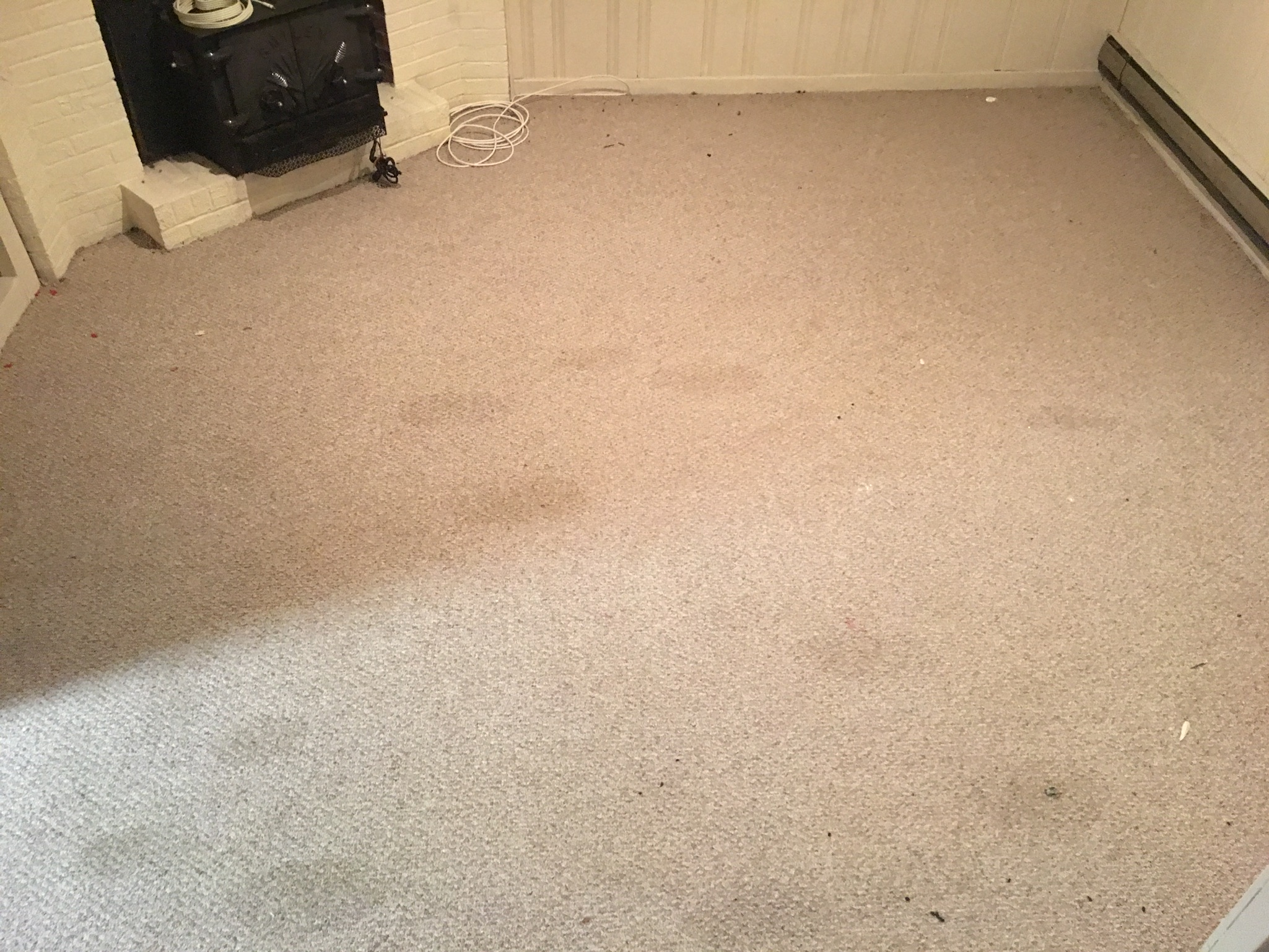 Residential fireplace room before carpet cleaning