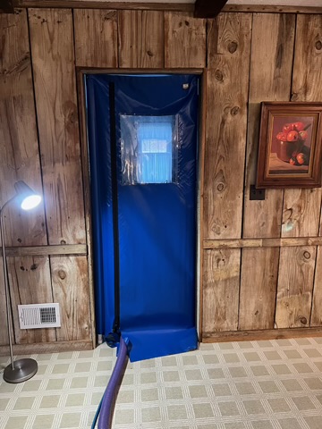 Interior view showing Seal-A-Door setup running hose indoors